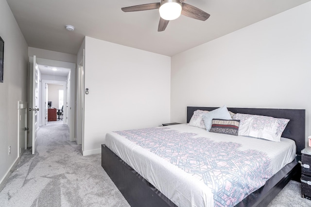 bedroom with baseboards, light colored carpet, and ceiling fan
