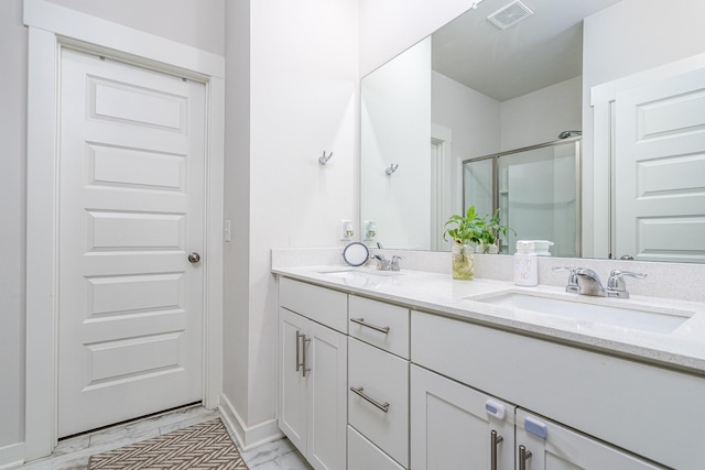 full bath featuring visible vents, a sink, marble finish floor, and a stall shower