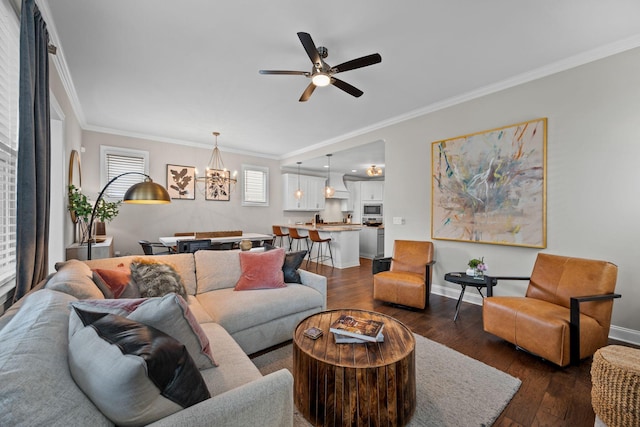 207 Moray Ct, Franklin, TN 37064 - living room with crown molding, baseboards, ceiling fan with notable chandelier, and dark wood-type flooring