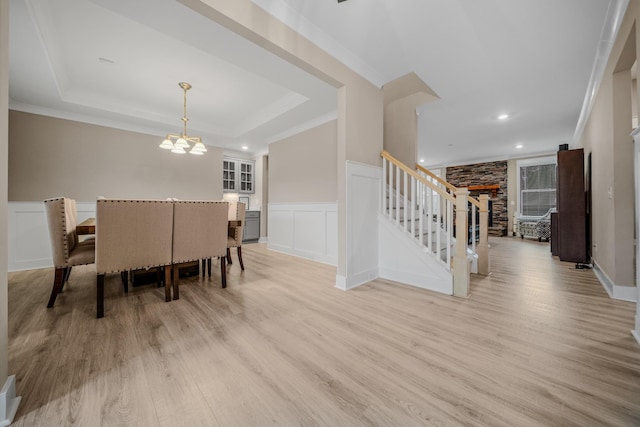 3032 Oxford Dr, Mount Juliet, TN 37122 - dining space featuring stairway, a wainscoted wall, a raised ceiling, light wood-style floors, and a notable chandelier