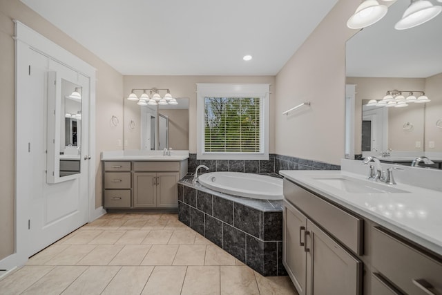 3032 Oxford Dr, Mount Juliet, TN 37122 - bathroom featuring two vanities, a garden tub, tile patterned flooring, and a sink