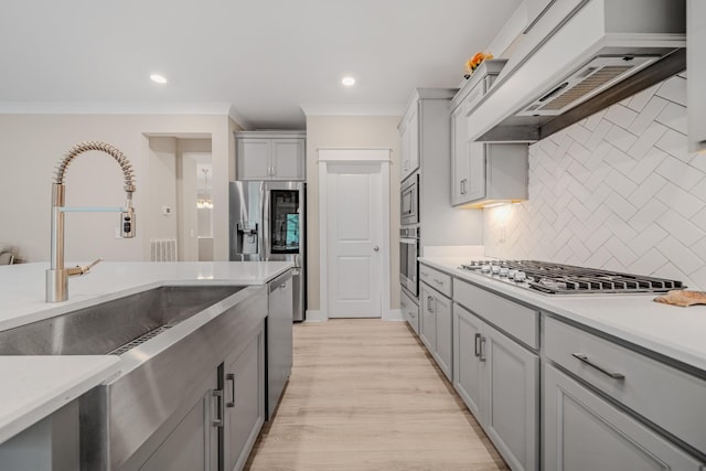 3032 Oxford Dr, Mount Juliet, TN 37122 - kitchen with a sink, custom exhaust hood, decorative backsplash, light countertops, and appliances with stainless steel finishes