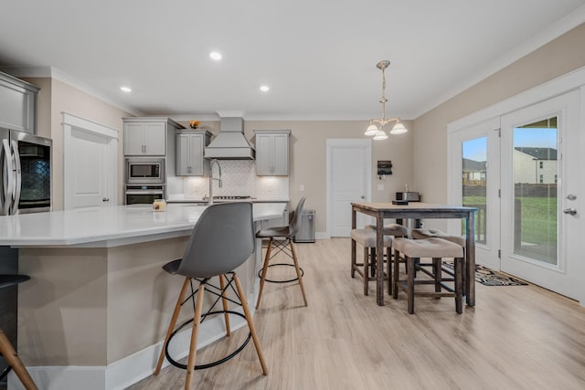 3032 Oxford Dr, Mount Juliet, TN 37122 - kitchen featuring ornamental molding, premium range hood, appliances with stainless steel finishes, and gray cabinets