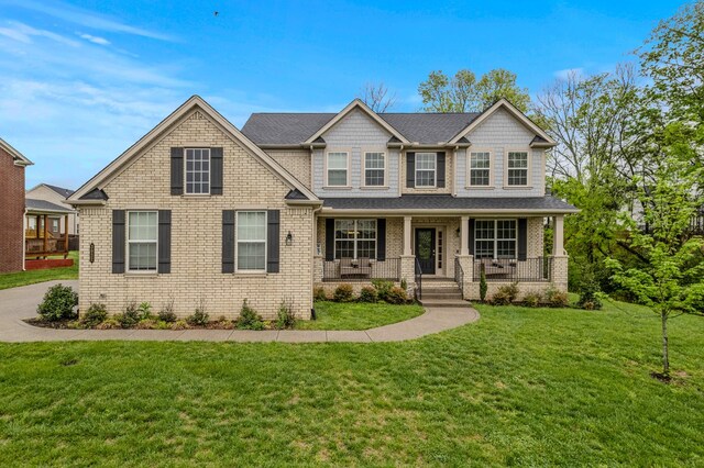 3032 Oxford Dr, Mount Juliet, TN 37122 - view of front of property with a porch, brick siding, a front yard, and roof with shingles