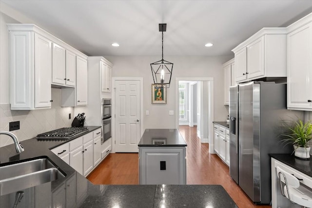 9502 Peebles Ct, Brentwood, TN 37027 - kitchen featuring white cabinets, dark countertops, wood finished floors, and a sink