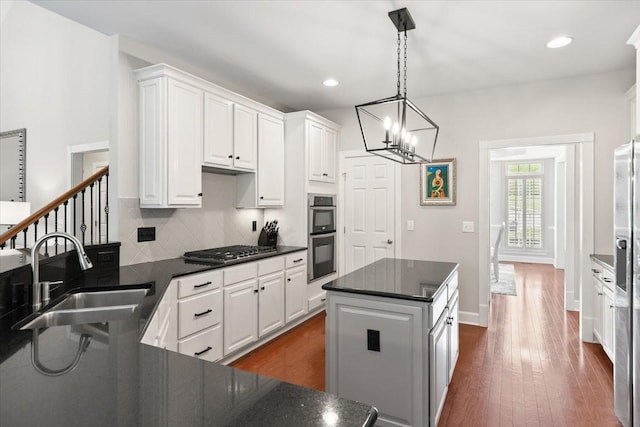 9502 Peebles Ct, Brentwood, TN 37027 - kitchen with white cabinets, dark countertops, a sink, and appliances with stainless steel finishes