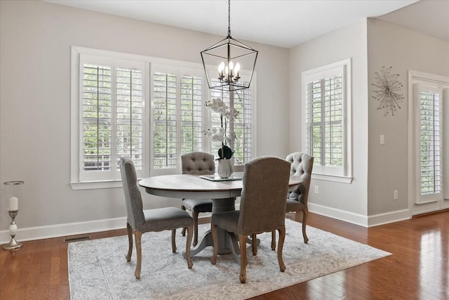 9502 Peebles Ct, Brentwood, TN 37027 - dining space with a chandelier, wood finished floors, visible vents, and baseboards