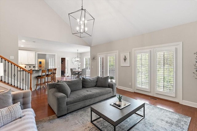 9502 Peebles Ct, Brentwood, TN 37027 - living area featuring visible vents, baseboards, a notable chandelier, wood finished floors, and stairs
