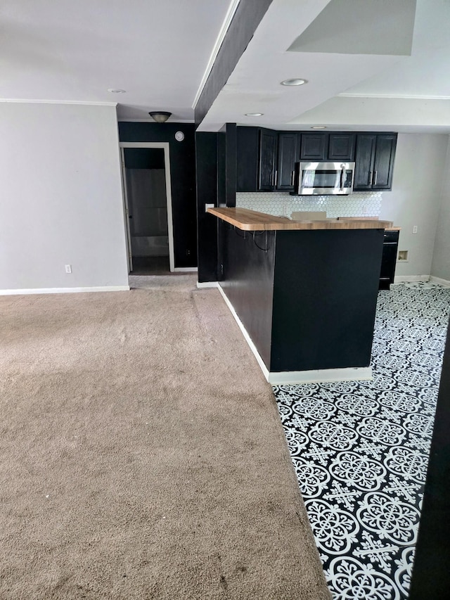 300 Hardin Ave, Dickson, TN 37055 - kitchen featuring stainless steel microwave, wood counters, dark cabinets, and baseboards
