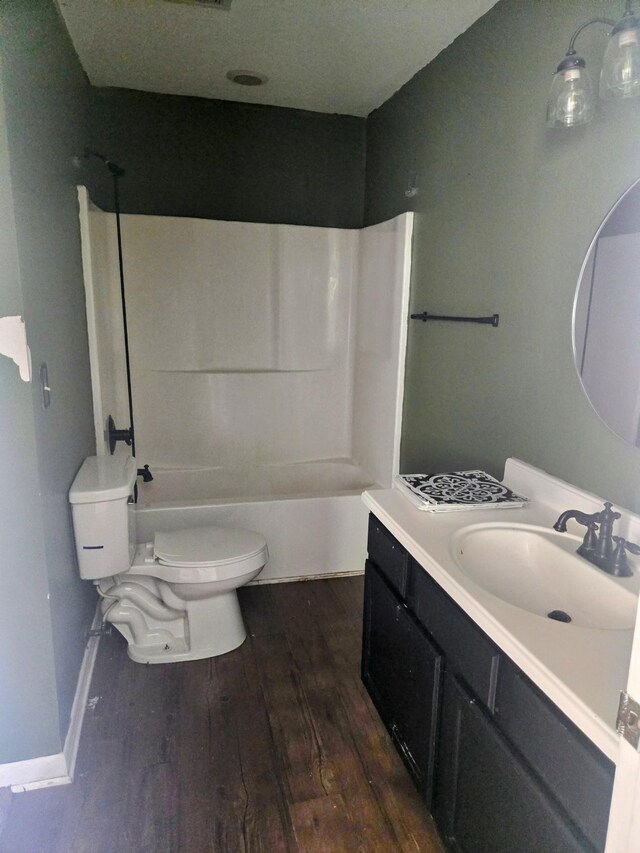 300 Hardin Ave, Dickson, TN 37055 - bathroom with wood-type flooring, toilet, vanity, and bathing tub / shower combination
