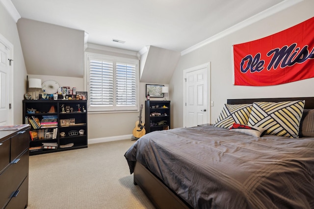 carpeted bedroom featuring baseboards, ornamental molding, and visible vents