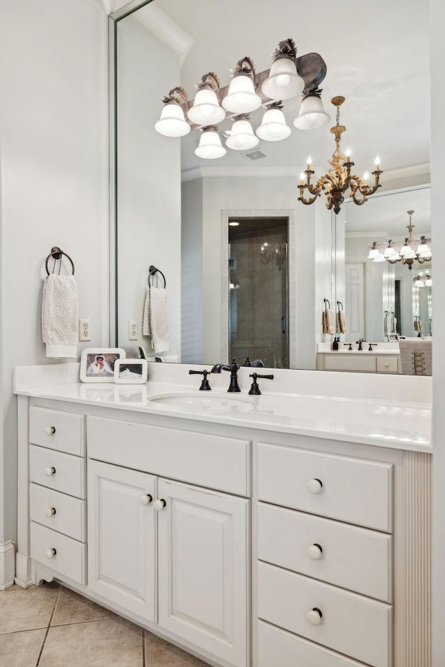 bathroom featuring a stall shower, vanity, an inviting chandelier, ornamental molding, and tile patterned flooring