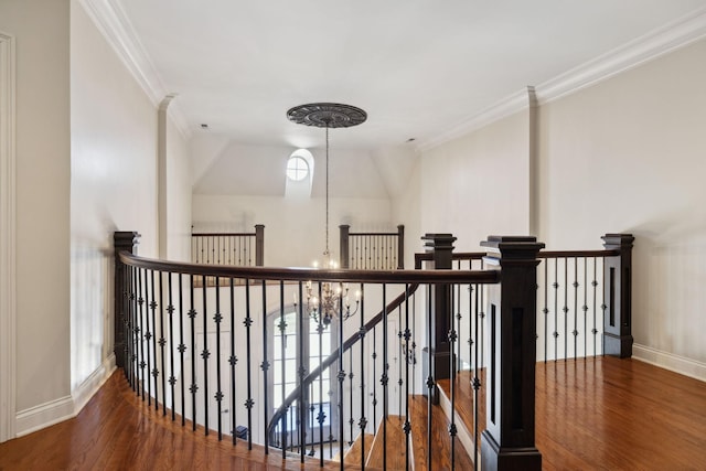 staircase featuring baseboards, wood finished floors, and ornamental molding