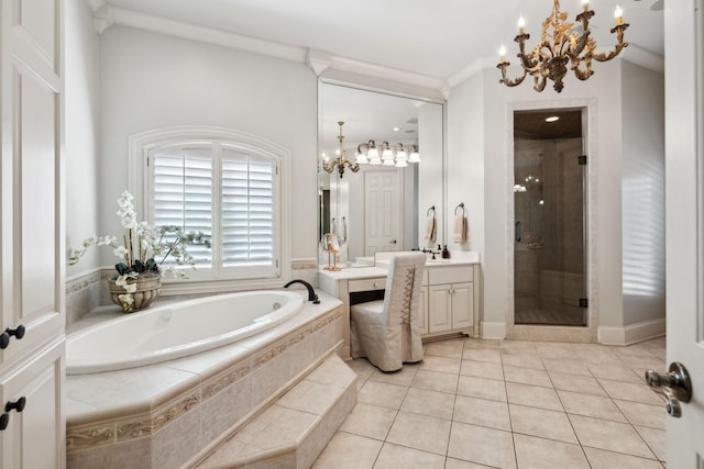 bathroom featuring a bath, vanity, a chandelier, and a stall shower