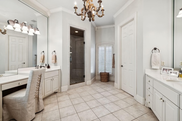 bathroom featuring a shower stall, a notable chandelier, ornamental molding, tile patterned flooring, and two vanities