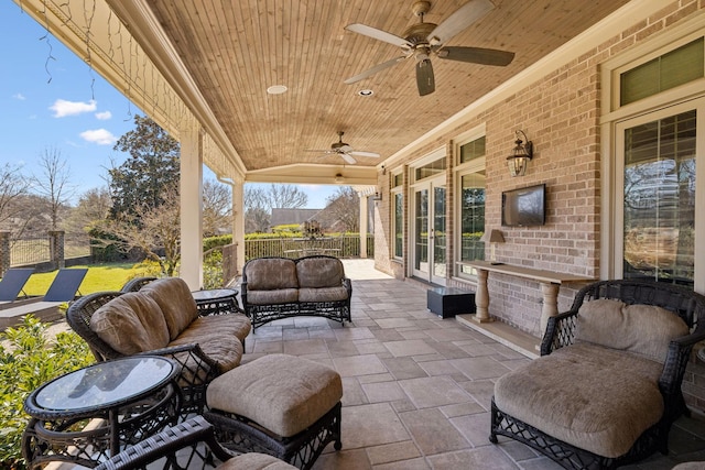 view of patio featuring outdoor lounge area, french doors, and ceiling fan