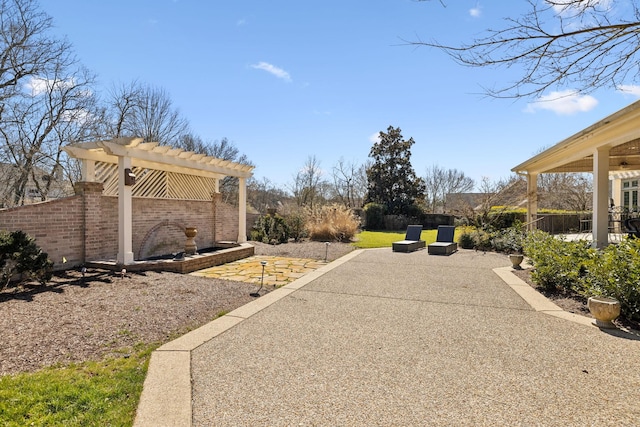view of yard with a pergola, a patio area, and fence