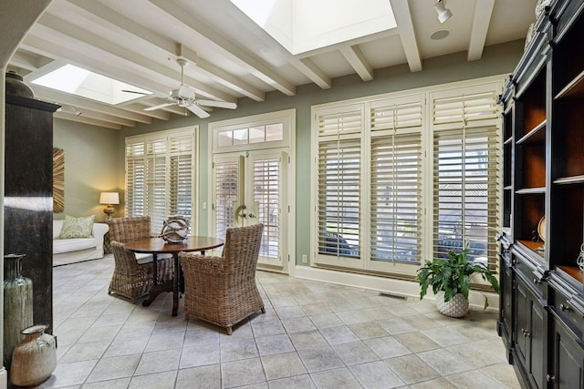 sunroom / solarium featuring beam ceiling, a skylight, french doors, and visible vents