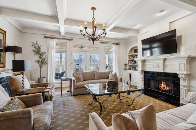living room featuring crown molding, a chandelier, a tile fireplace, and beamed ceiling