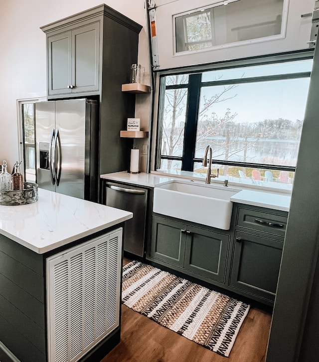 135 Hemlock Cv, Tracy City, TN 37387 - kitchen featuring open shelves, dark wood-style flooring, light stone counters, a sink, and stainless steel appliances