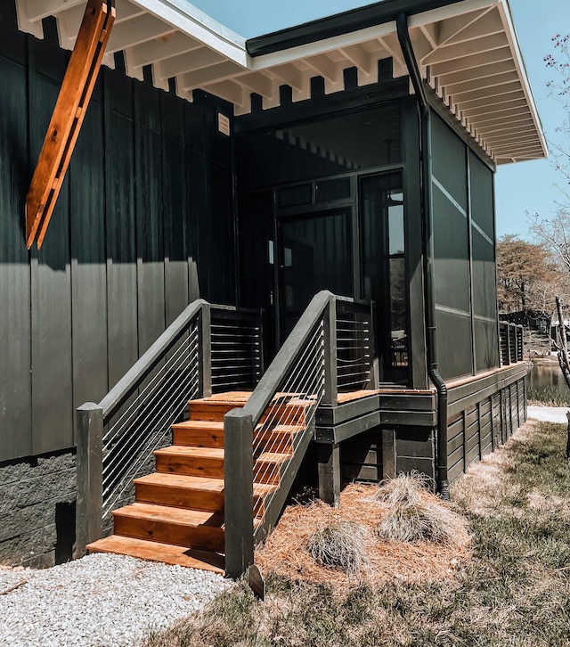 135 Hemlock Cv, Tracy City, TN 37387 - view of home's exterior with board and batten siding and a sunroom