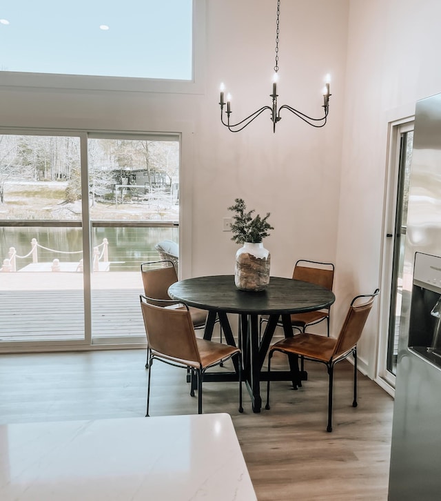 135 Hemlock Cv, Tracy City, TN 37387 - dining space featuring an inviting chandelier, light wood-style flooring, and plenty of natural light