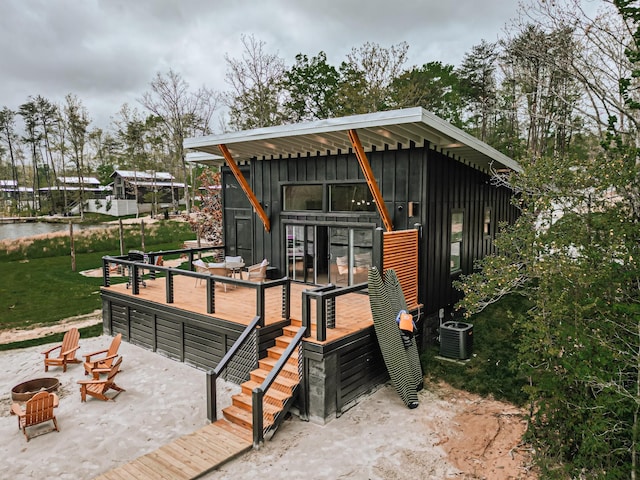 135 Hemlock Cv, Tracy City, TN 37387 - modern home with board and batten siding, central AC, a wooden deck, and an outdoor structure