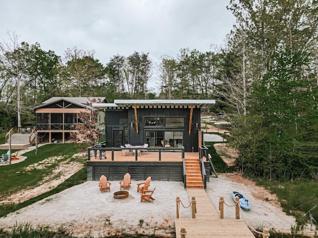 135 Hemlock Cv, Tracy City, TN 37387 - rear view of property with stairs, a wooden deck, a sunroom, and an outdoor fire pit
