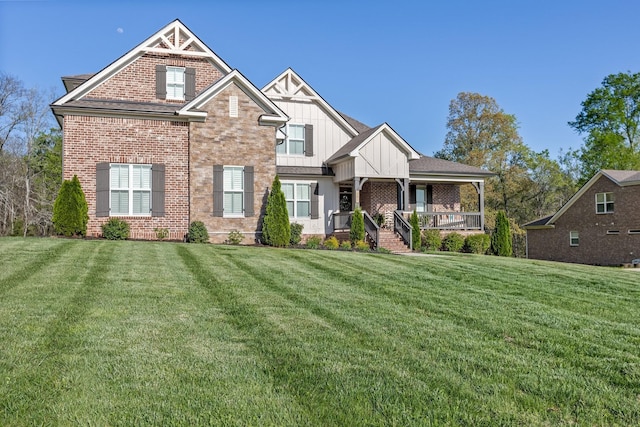 craftsman inspired home featuring brick siding, board and batten siding, a front lawn, and a porch