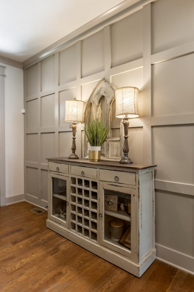 bar featuring wood finished floors and baseboards