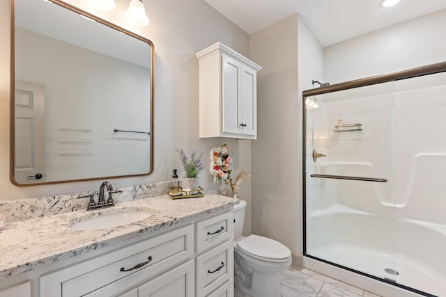 bathroom with vanity, marble finish floor, a stall shower, and toilet