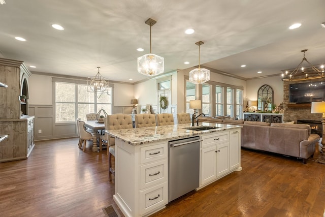 kitchen with a notable chandelier, stainless steel dishwasher, and a sink