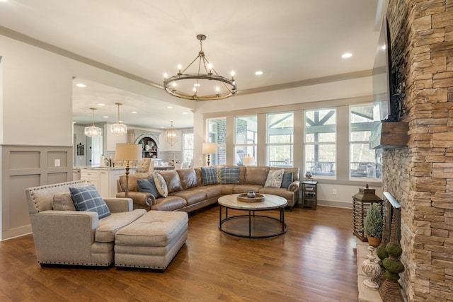 living room with ornamental molding, dark wood-style flooring, a chandelier, and recessed lighting