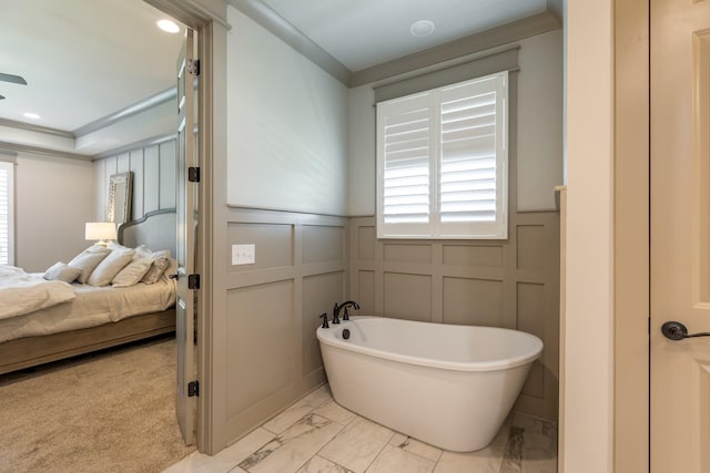 bathroom featuring a soaking tub, ensuite bath, marble finish floor, and a decorative wall