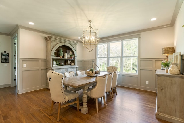 dining room featuring wainscoting, a decorative wall, recessed lighting, and an inviting chandelier