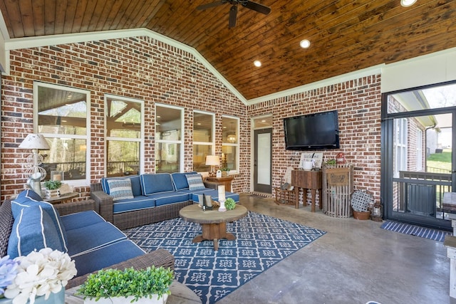 living room featuring ceiling fan, wood ceiling, finished concrete floors, high vaulted ceiling, and brick wall