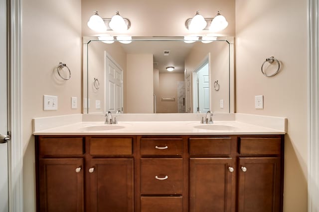 bathroom featuring a sink and double vanity