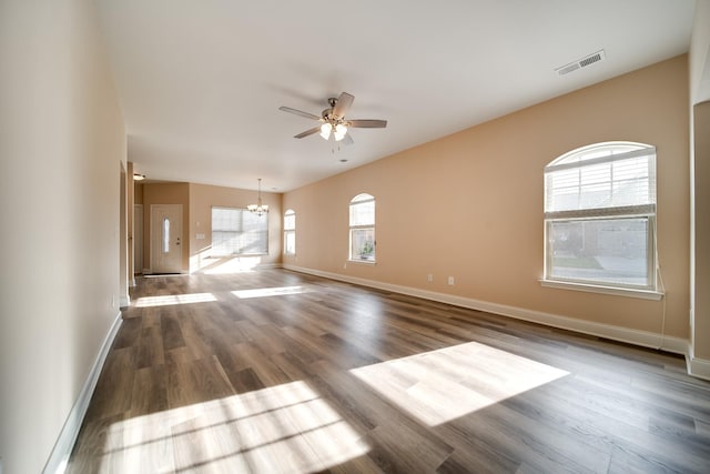 empty room with wood finished floors, baseboards, and ceiling fan with notable chandelier