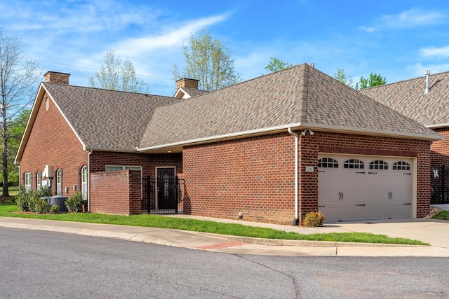 exterior space with brick siding, roof with shingles, and a chimney