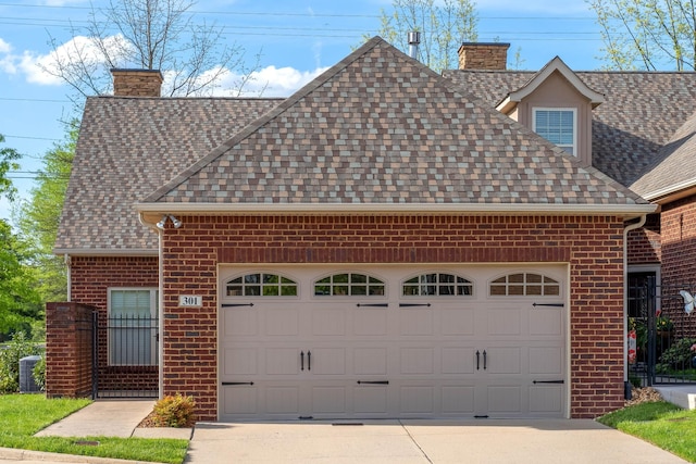 view of front of home featuring a chimney, roof with shingles, and brick siding