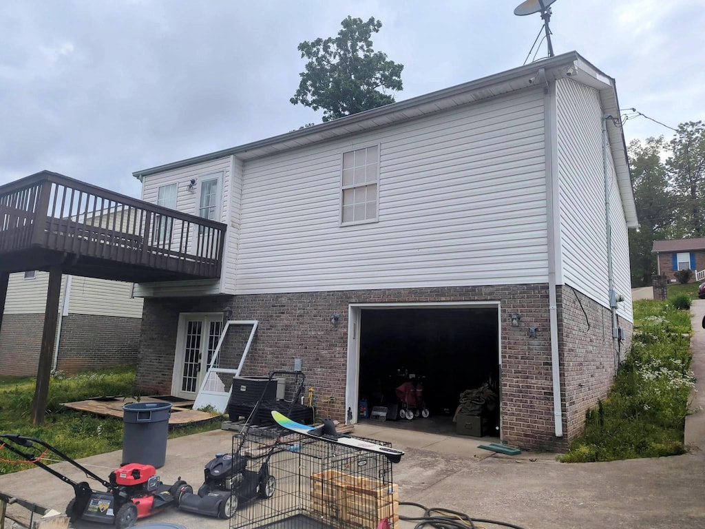 344 Donna Dr, Clarksville, TN 37042 - back of house with concrete driveway, a wooden deck, a garage, and brick siding