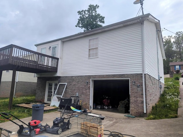 344 Donna Dr, Clarksville, TN 37042 - back of house with concrete driveway, a wooden deck, a garage, and brick siding