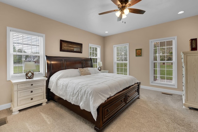 bedroom with baseboards, recessed lighting, a ceiling fan, and light colored carpet