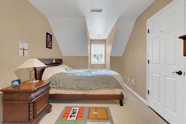 bedroom with baseboards, visible vents, carpet floors, and lofted ceiling