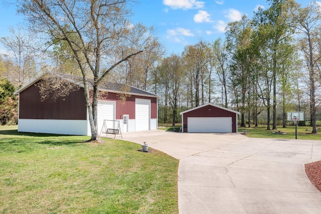 view of side of property featuring an outbuilding, a yard, and a garage