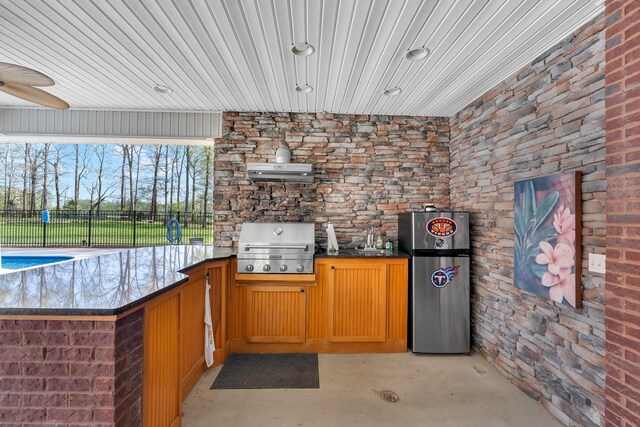 view of patio / terrace with fence, area for grilling, and a sink