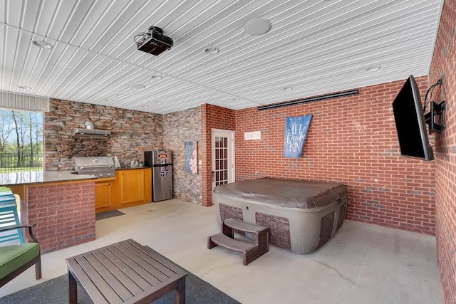 view of patio / terrace with area for grilling and an indoor hot tub