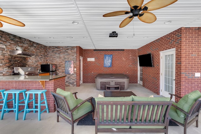 view of patio with area for grilling, exterior kitchen, ceiling fan, and outdoor wet bar
