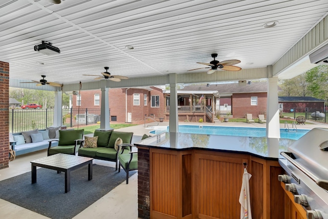 view of patio / terrace featuring a grill, fence, a ceiling fan, and an outdoor hangout area