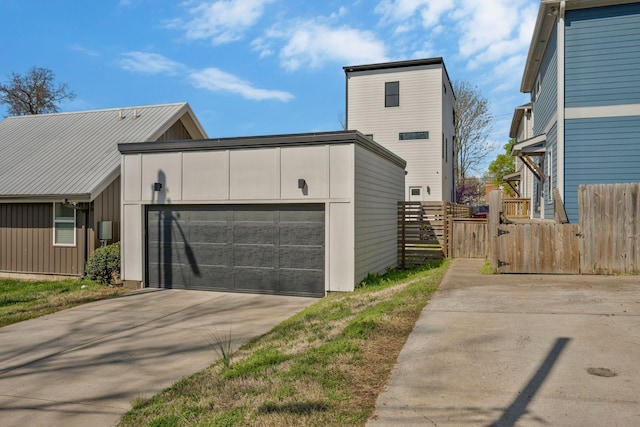 view of front of home with concrete driveway, fence, and an attached garage